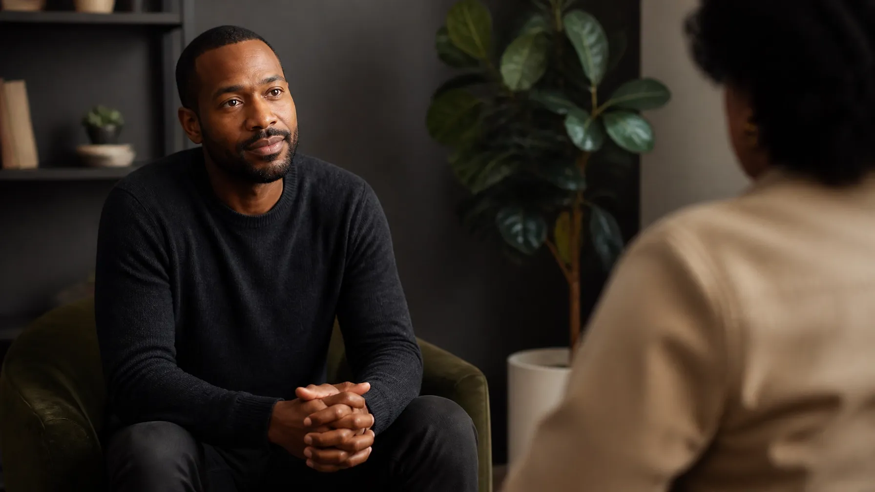African-American man seated in a welcoming office, ready for an honest conversation.
